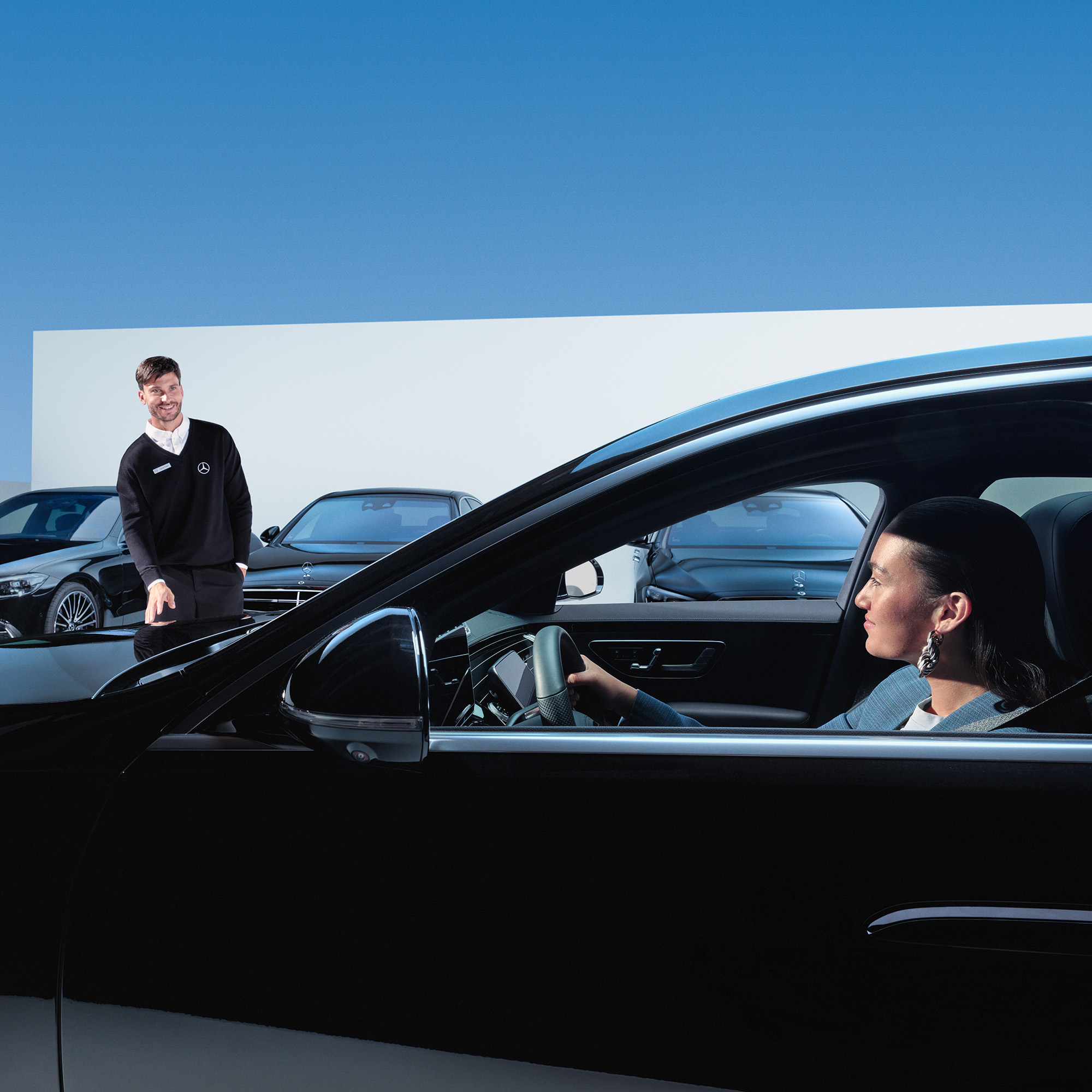 Mobilo sikrer din mobilitet | Servicecheck | Mercedes-Benz Kvinde i bil smiler til Mercedes-Benz servicemedarbejder