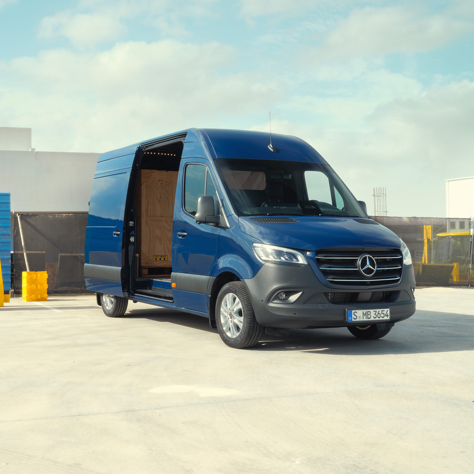 Ny Sprinter og eSprinter hæver standarden | Mercedes-Benz Vans Mørkeblå Sprinter holder parkeret med sidedøren åben