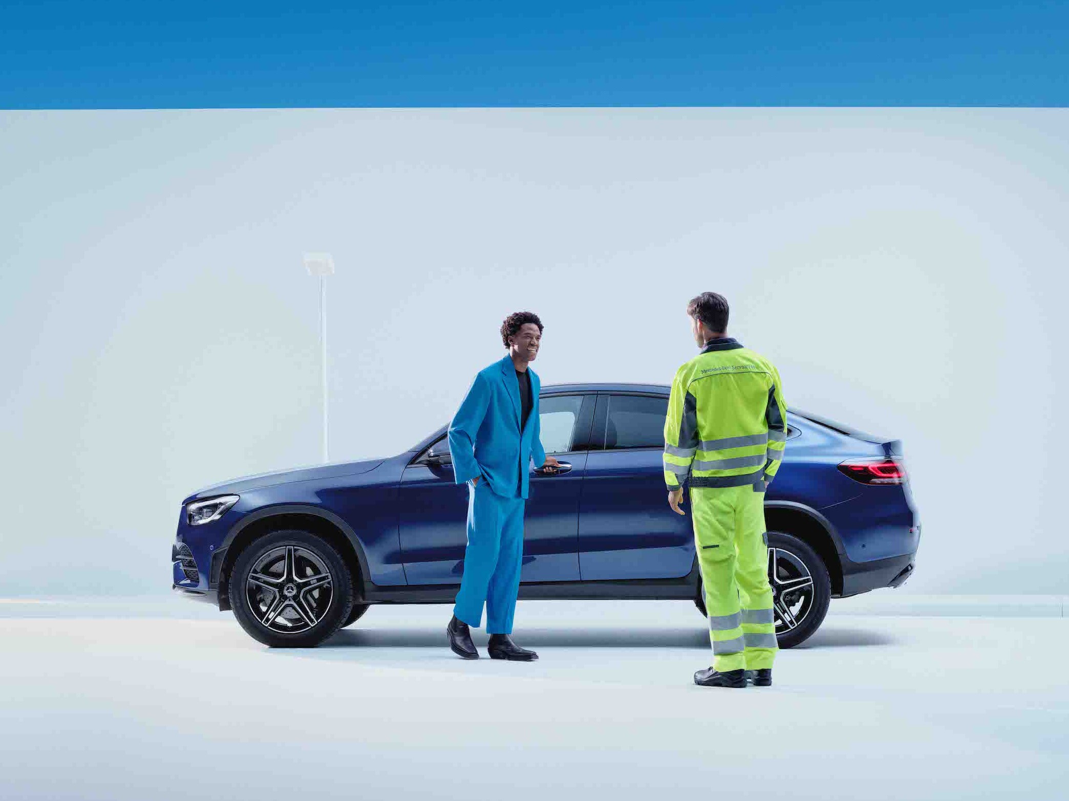 Mand taler med Mercedes-Benz servicemedarbejder foran sin bil