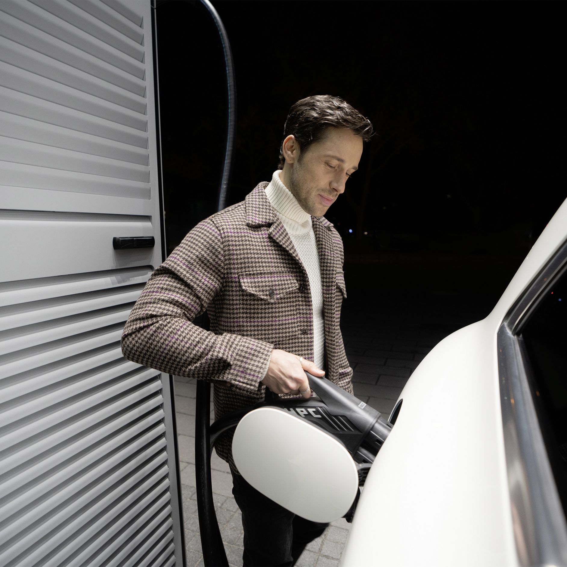 Offentlig opladning | Opladningsløsninger for erhvervskunder | Mercedes-Benz Mand oplader sin elektriske Mercedes-Benz bil ved en ladestander