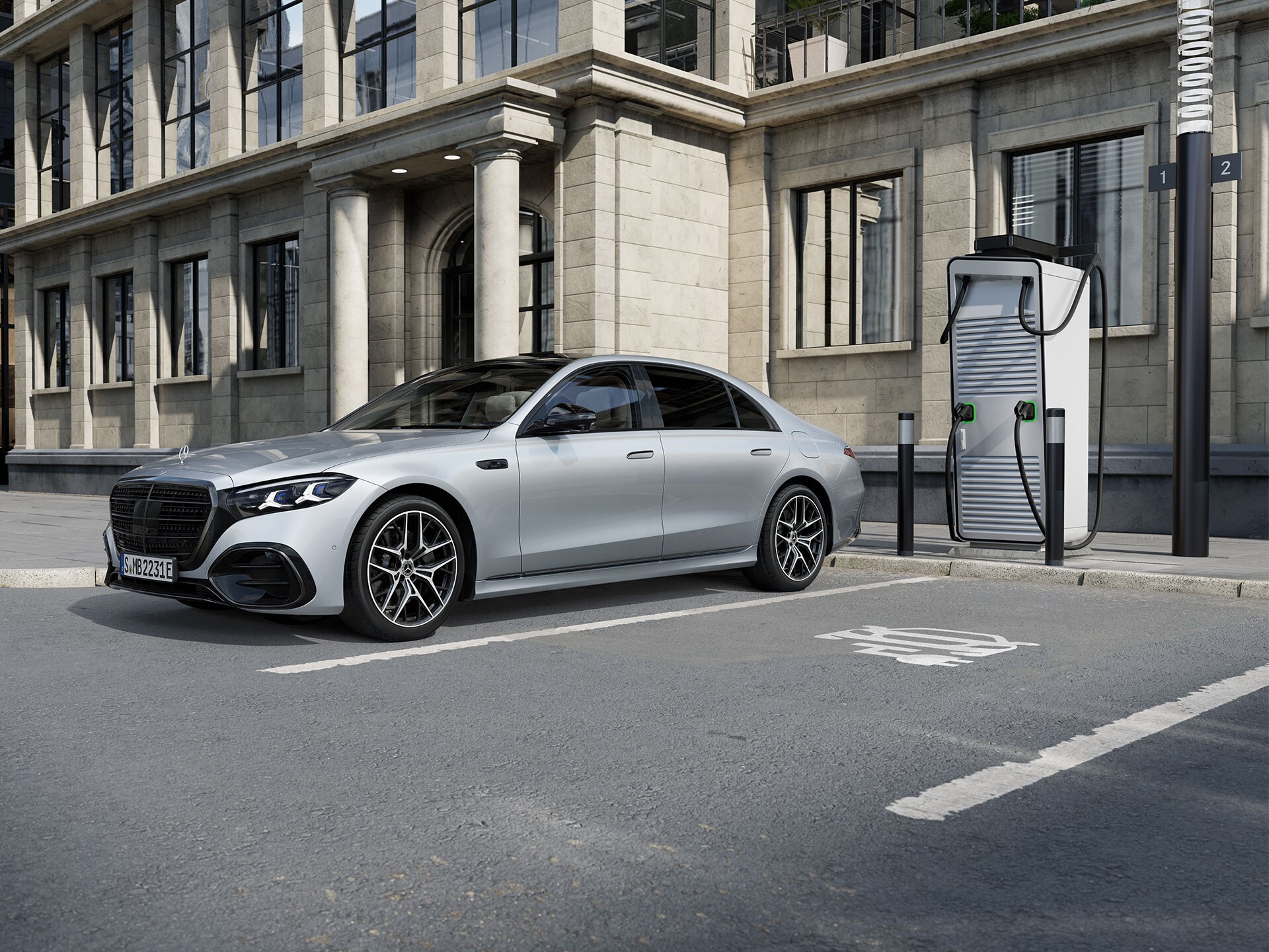 Mercedes-Benz S-Klasse lang sedan, plug-in-hybrid set i syv-ottendedels vinkel fra siden, på en parkeringsplads ved siden af en ladestation.