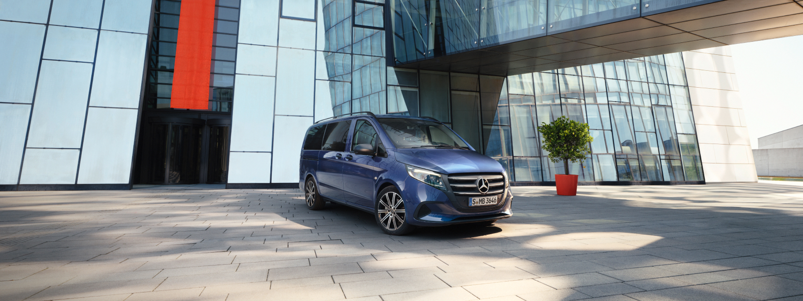 Modeloversigt | Vito Tourer | Mercedes-Benz Vans Mercedes-Benz Vito Tourer foran en kontorbygning