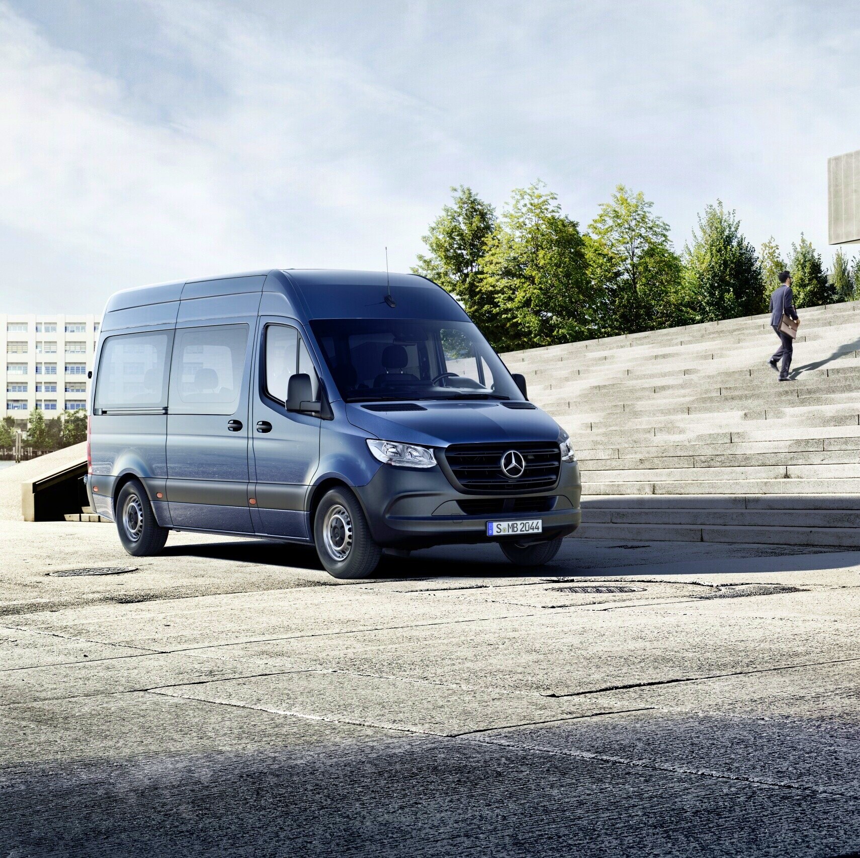 Blå Mercedes-Benz Sprinter Tourer foran trappe op til en bygning