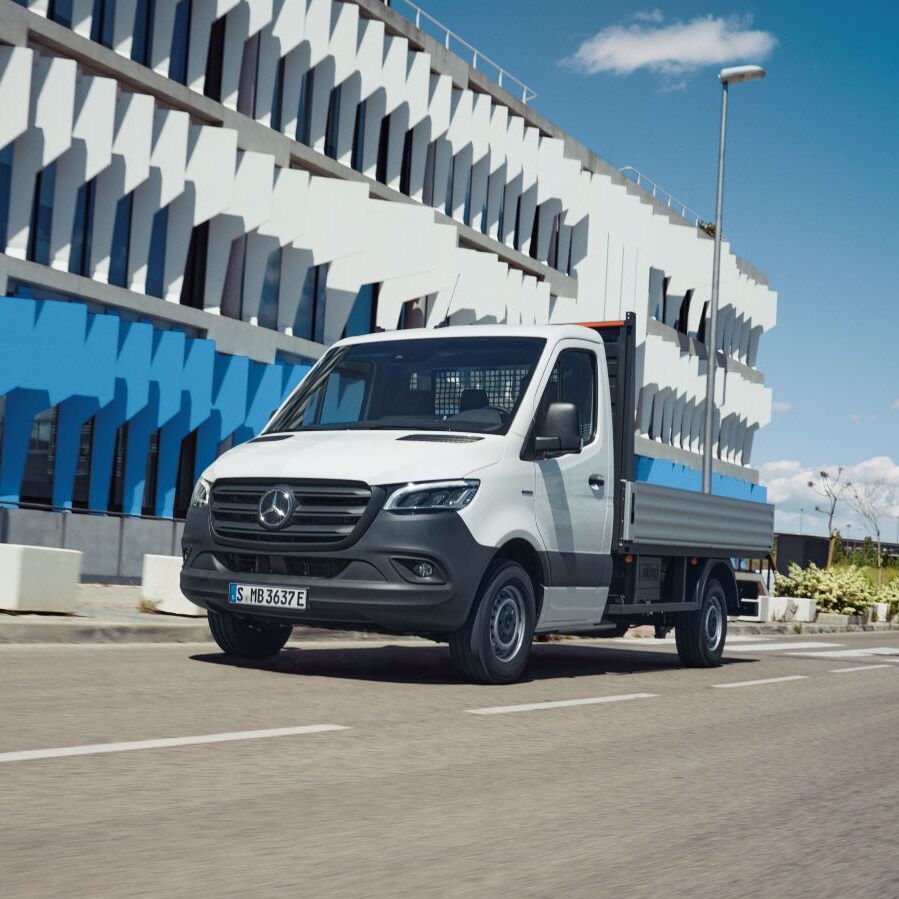 Mercedes-Benz eSprinter Chassis som ladvogn kører forbi kontorbygning