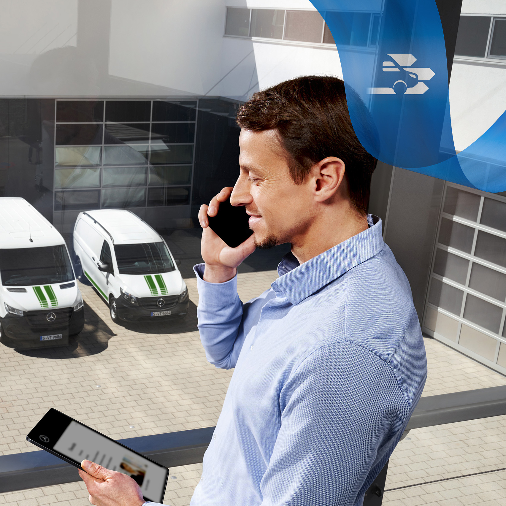 Mercedes-Benz | Flådetjenester til varebiler Mand taler i telefon, mens han kigger på en tablet, med en række Mercedes-Benz varebiler i baggrunden.